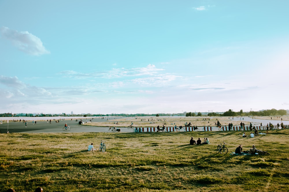 a large field with people and horses