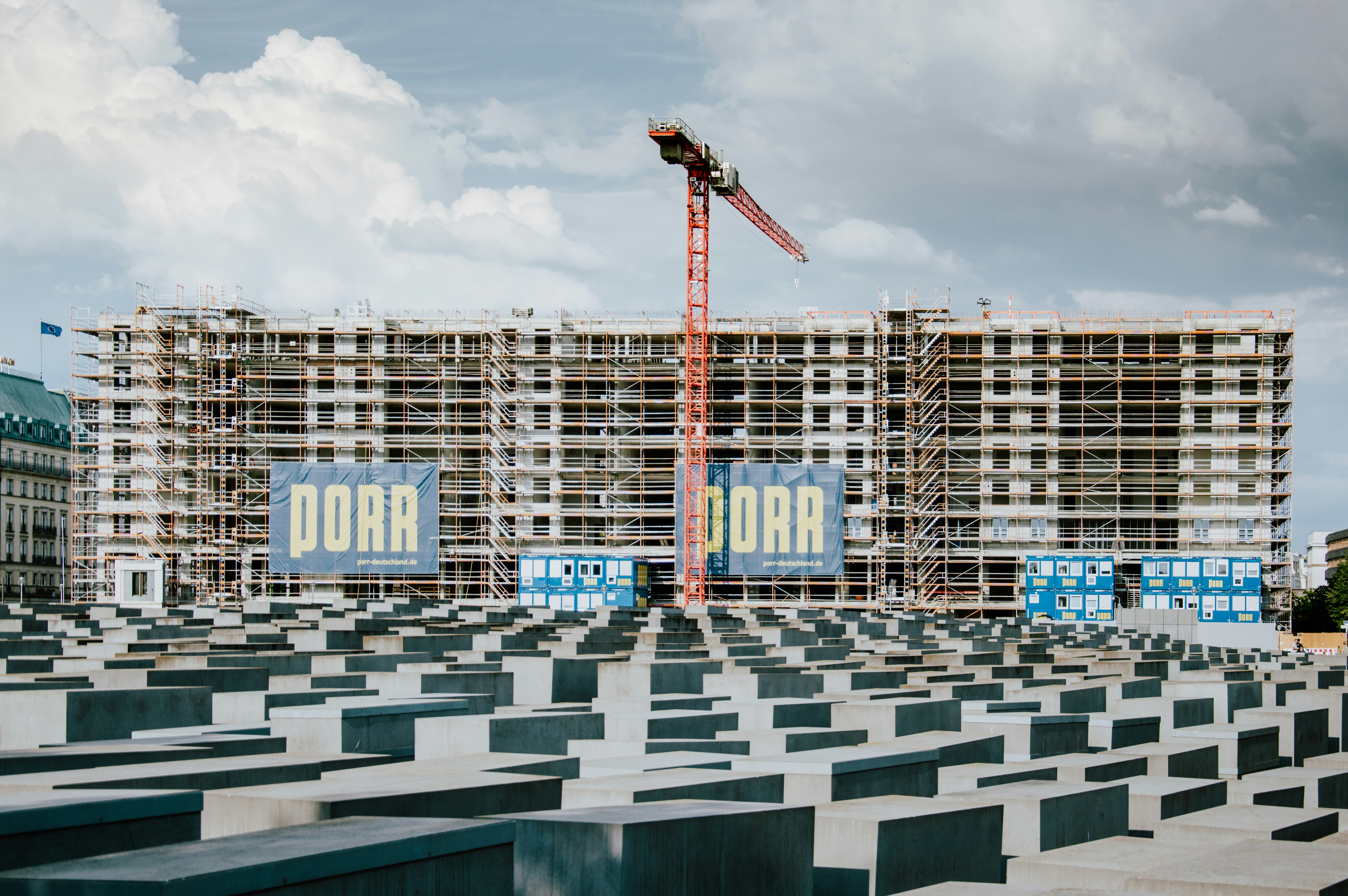 Prefabricated modular building structure on a construction site, grey sky and open field