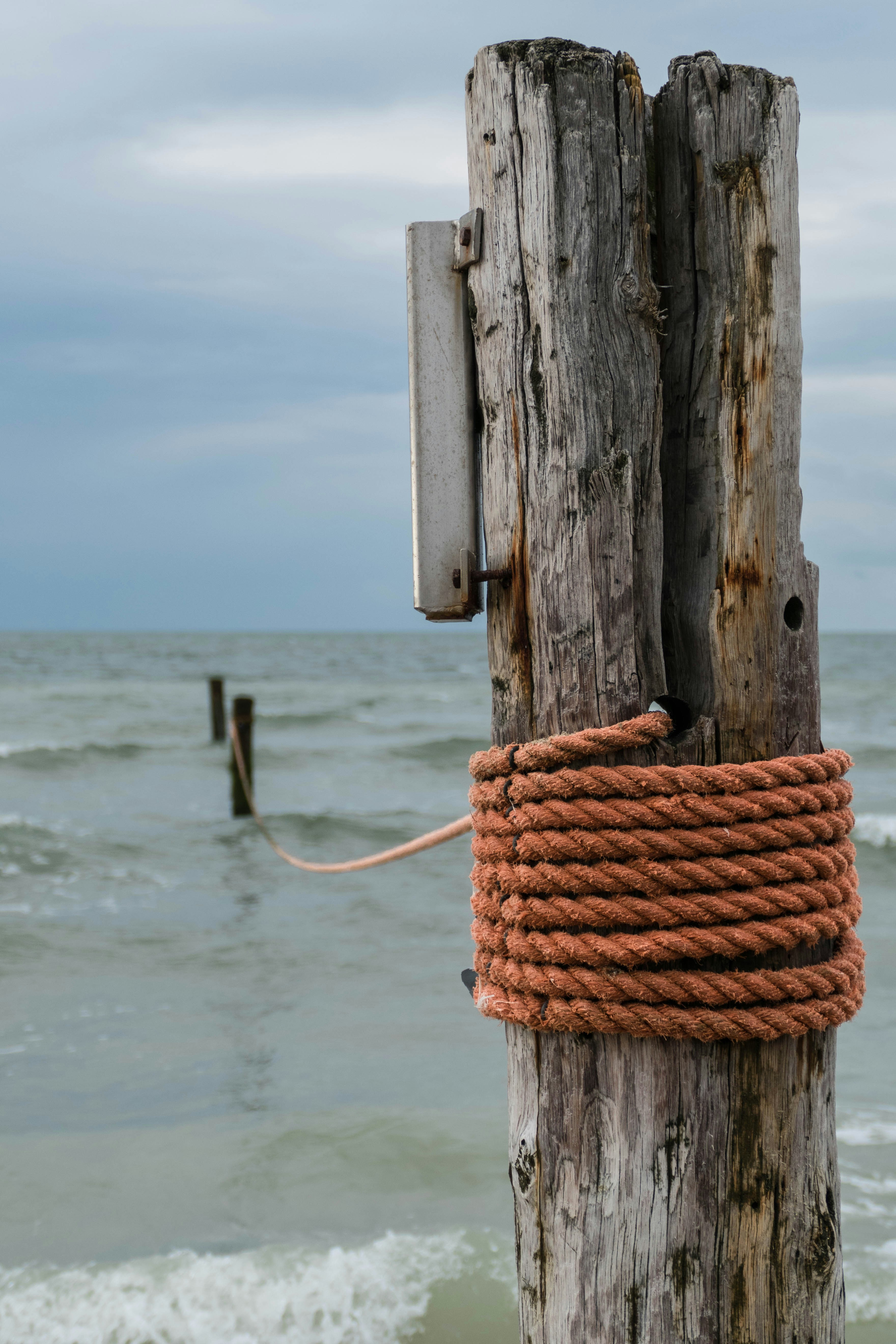 a wood post with a rope tied to it with a rope tied to it