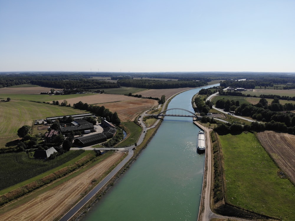 a river with a bridge and buildings