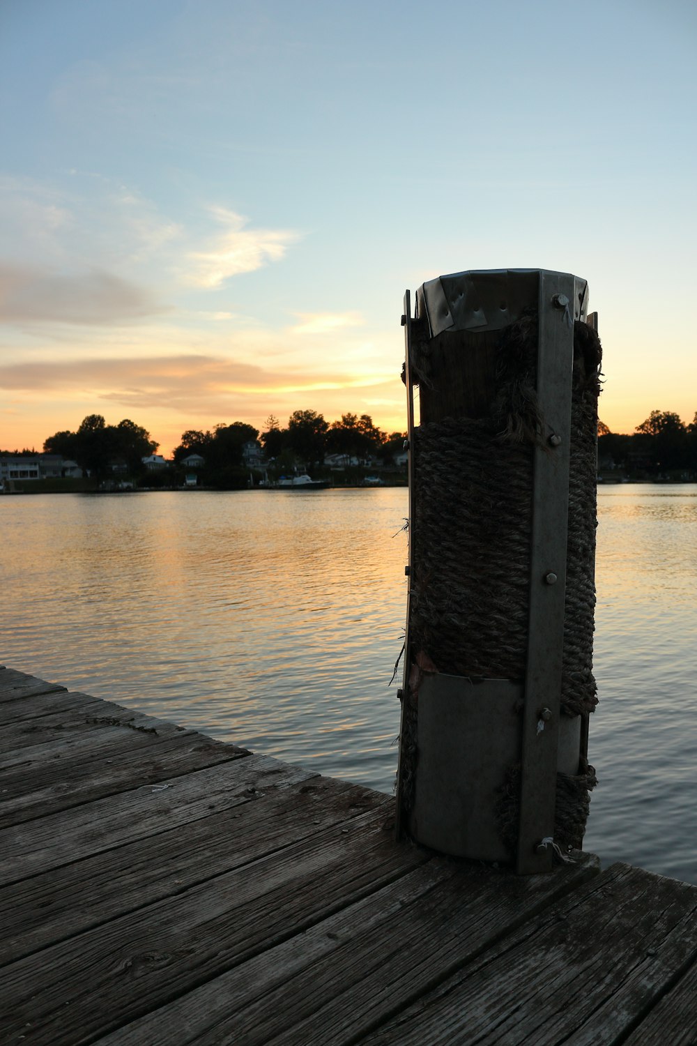 a wooden dock with a large stone pillar on it