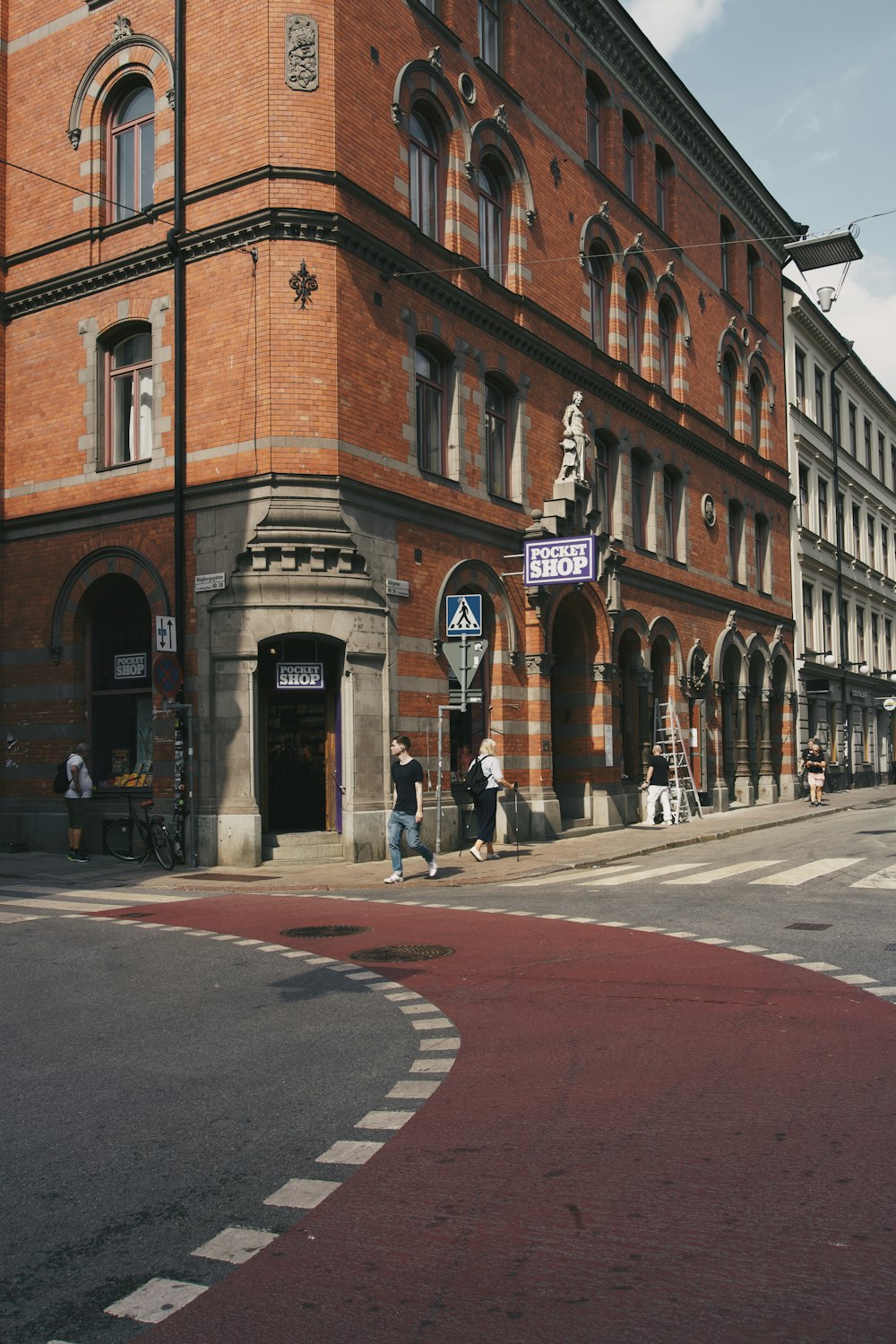 a brick building with people walking around