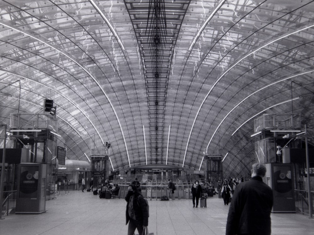 a large room with people and a large glass ceiling