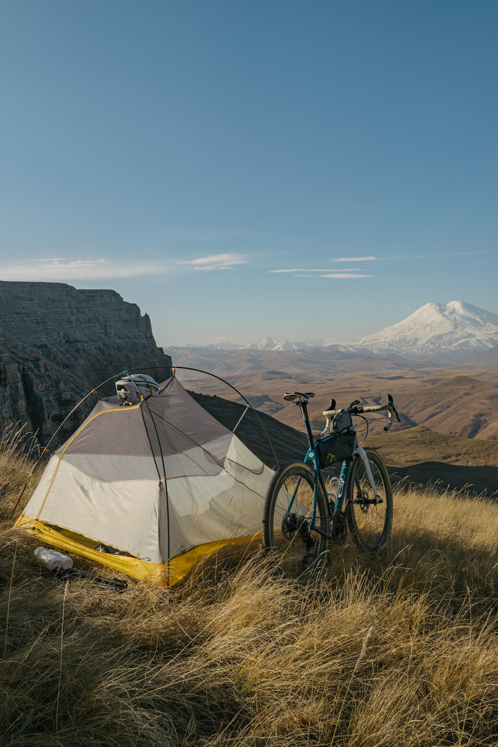 a bicycle parked next to a tent