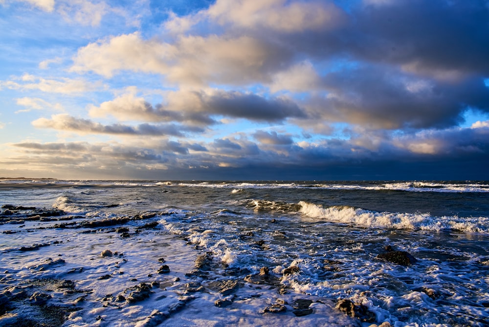 a rocky beach with waves crashing