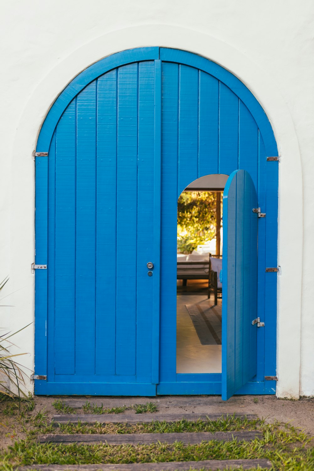 a blue door with a bench in the background