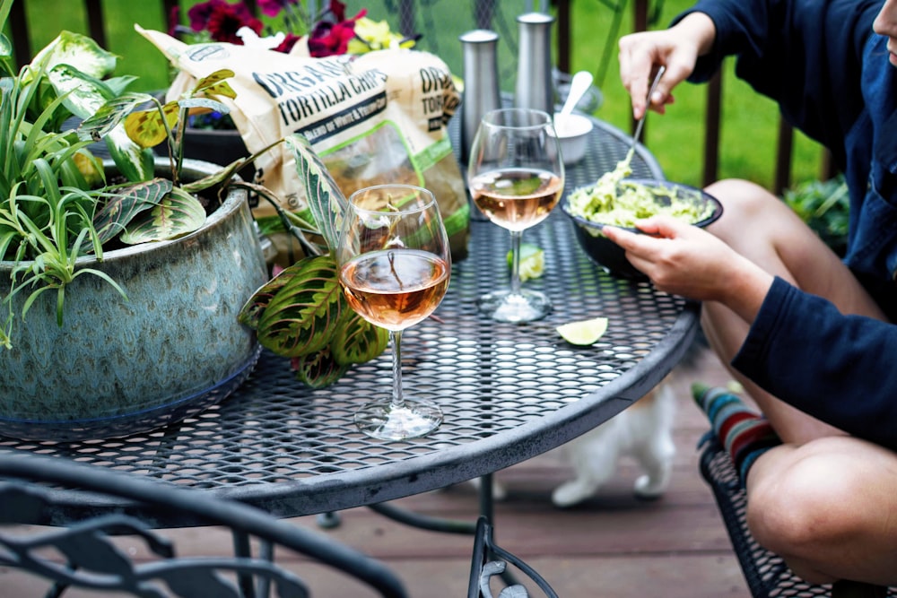 a table with wine glasses and food