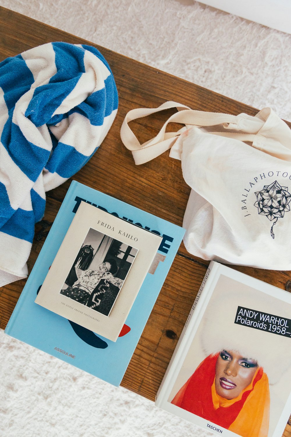 a group of books and a towel on a bed