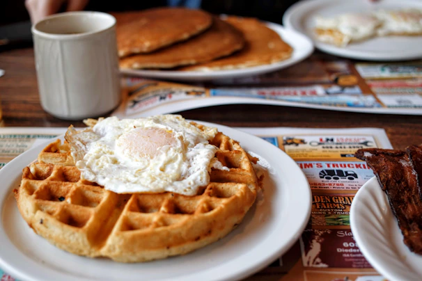 a plate of pancakes and a cup of coffee