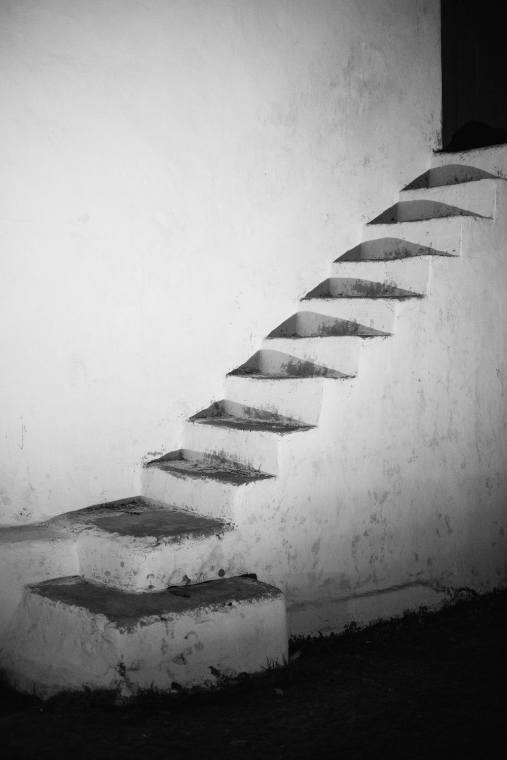 a staircase with a white wall