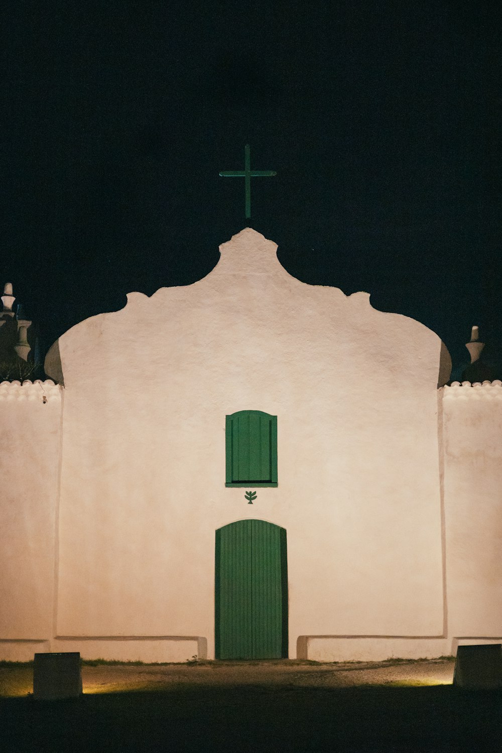 a white building with a green door