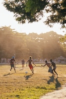 A group of young people playing soccer during a community sports event.