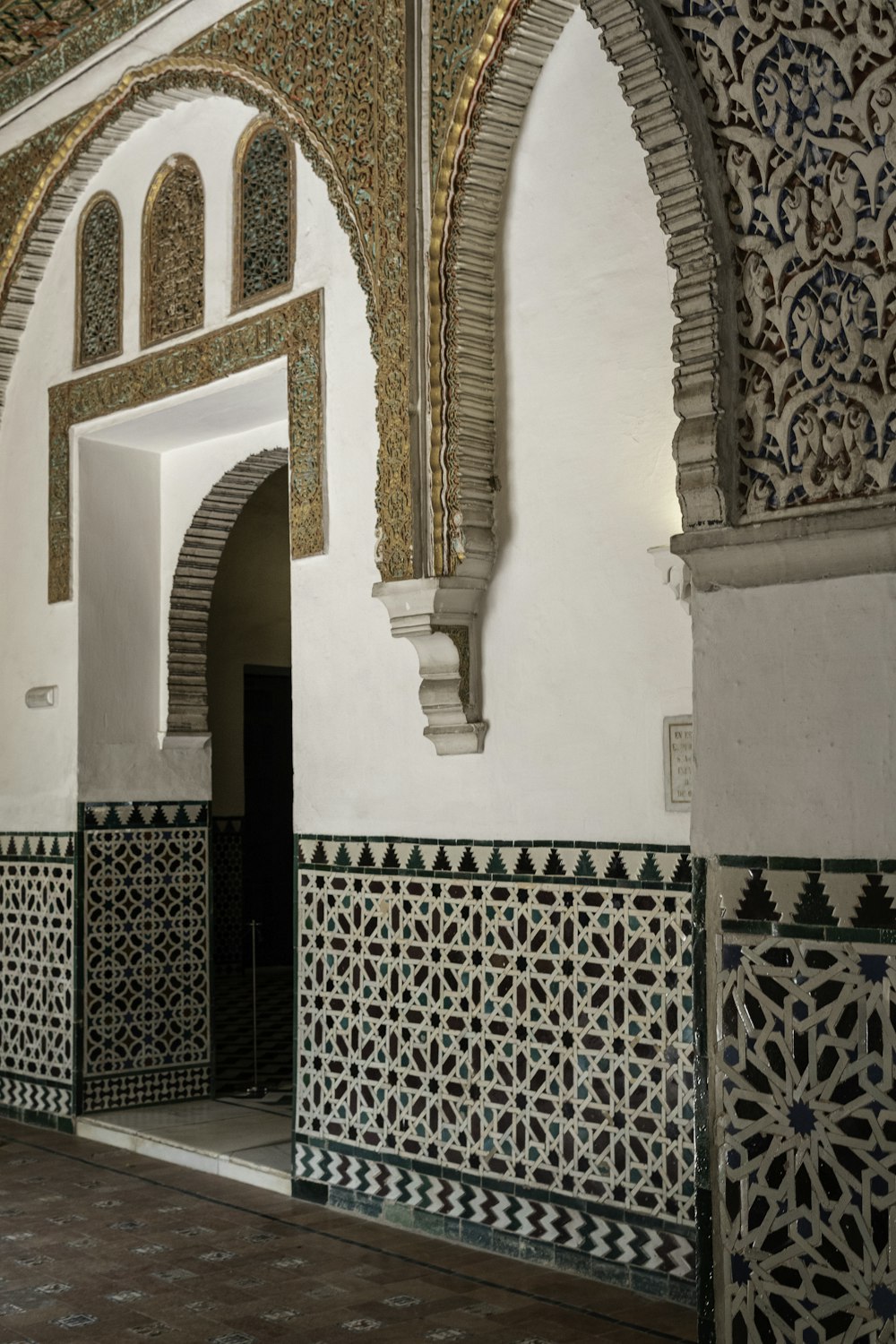 a room with a tile floor and a wall with a design on it