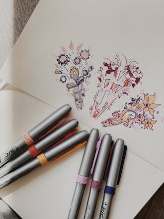 a group of pens on a table