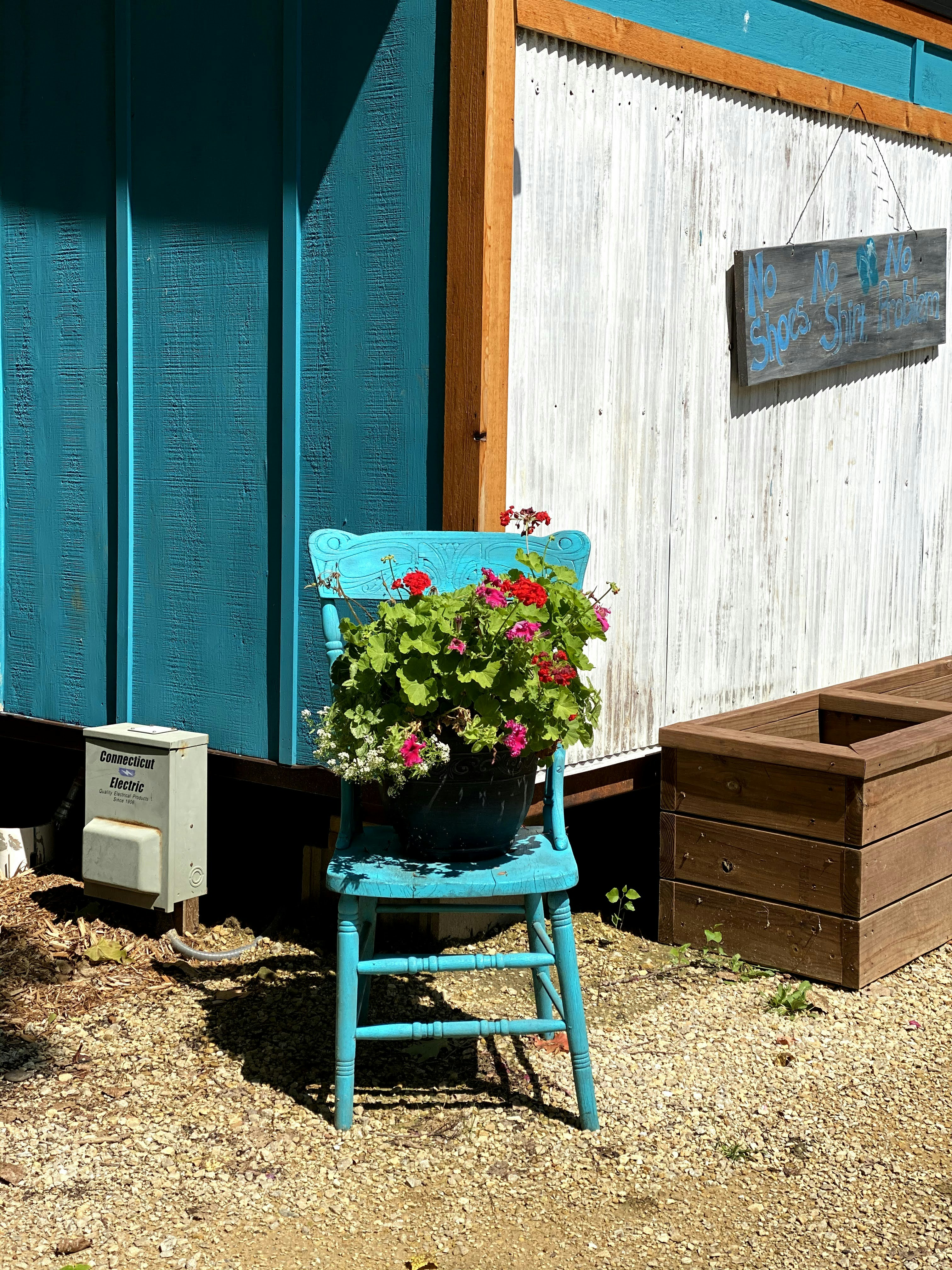 a blue chair with flowers in it