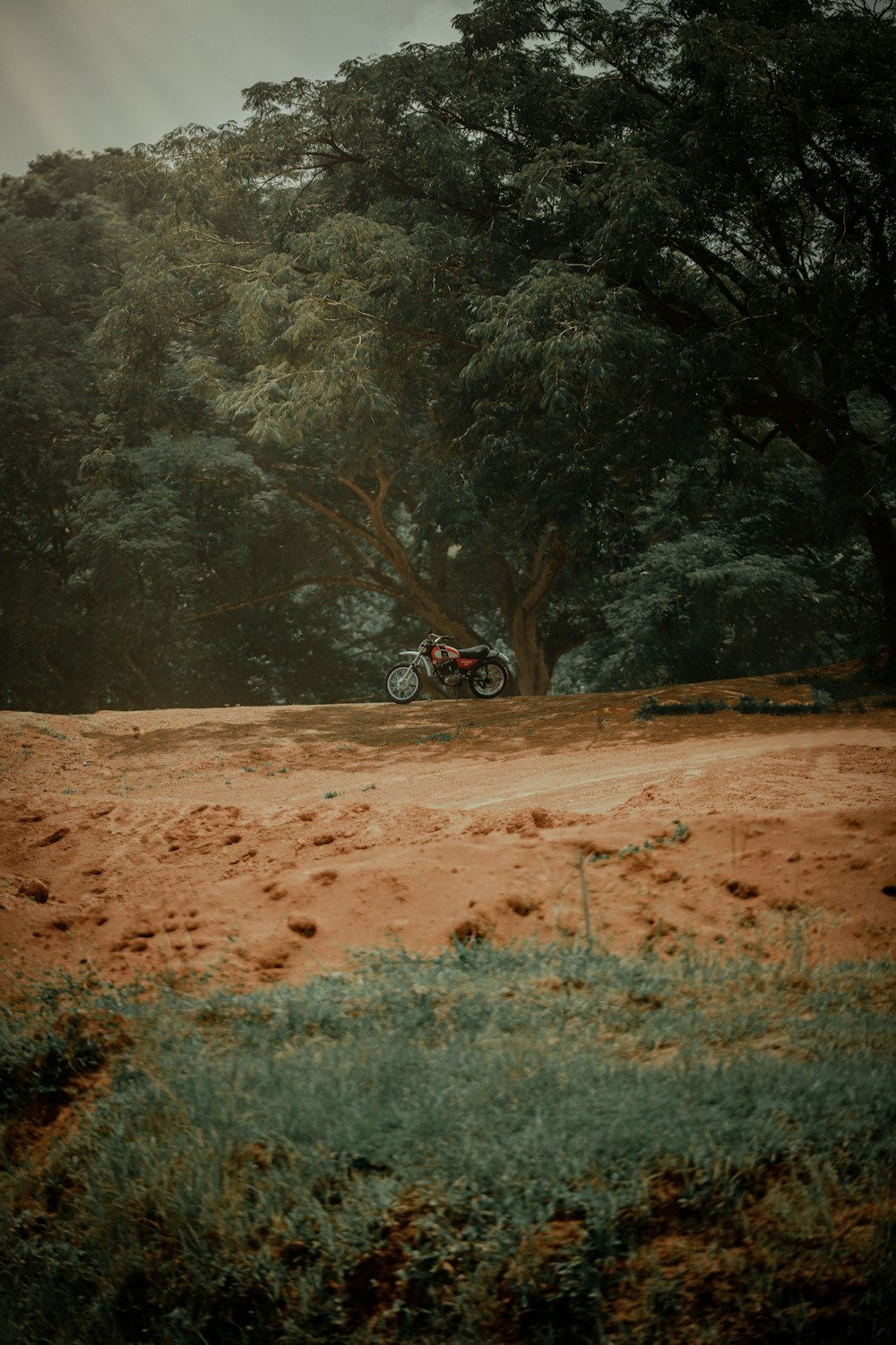 a motorcycle parked on a dirt road