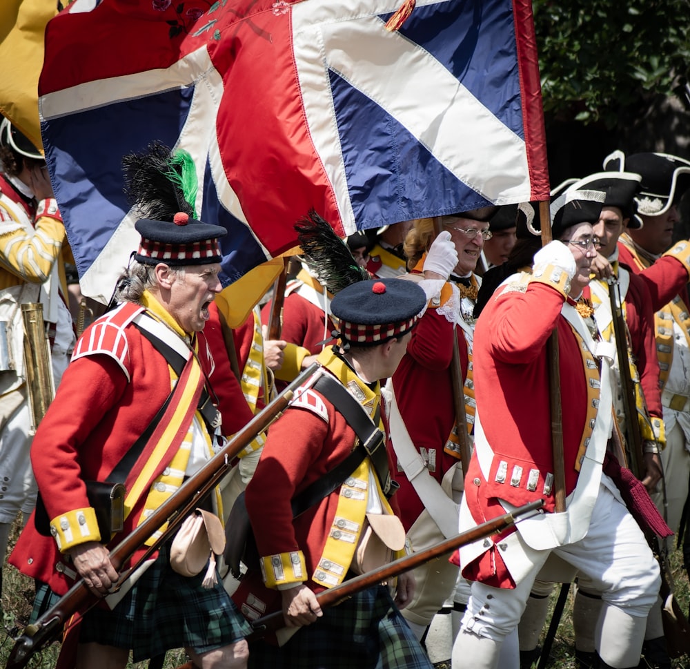 eine Gruppe von Menschen in Uniform, die Flaggen halten