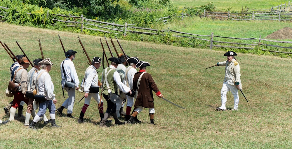 a group of men in uniform holding baseball bats