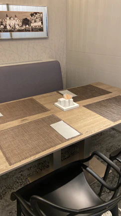Elegant dining setup showcasing photo-printed placemats with forest and mountain scenes.