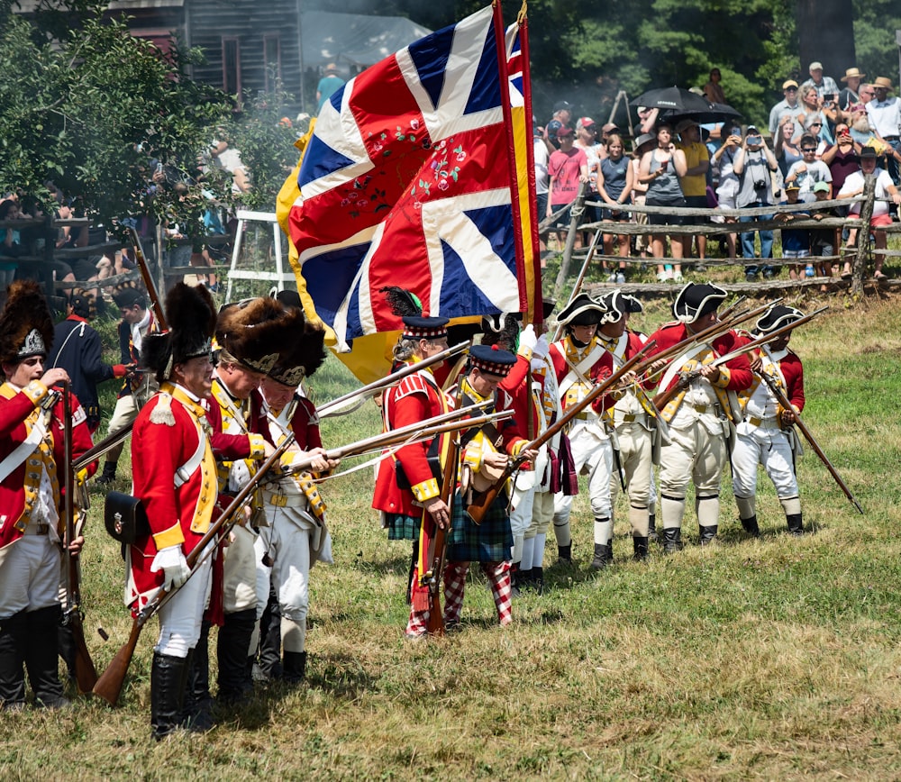 a group of people in uniform holding flags and a flag