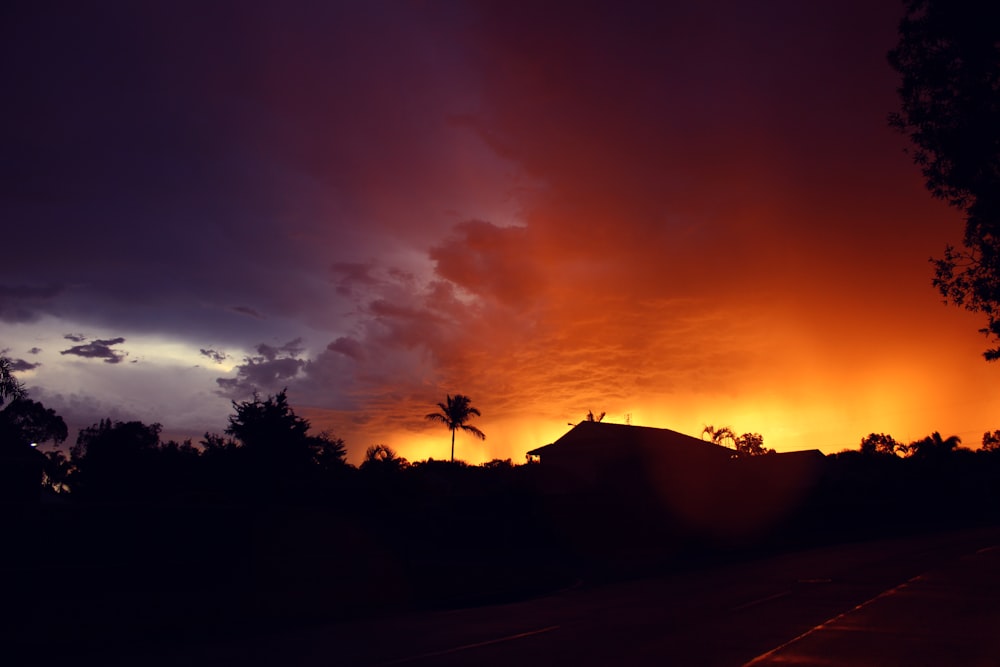 a sunset over a hill