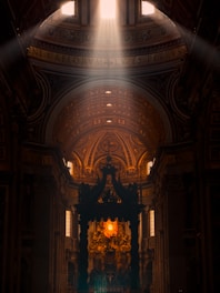 Sunlight streaming through stained glass windows inside St. Peter Church during a morning service.