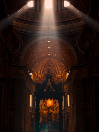 Sunlight streaming through stained glass windows illuminating the prayer hall during morning services.