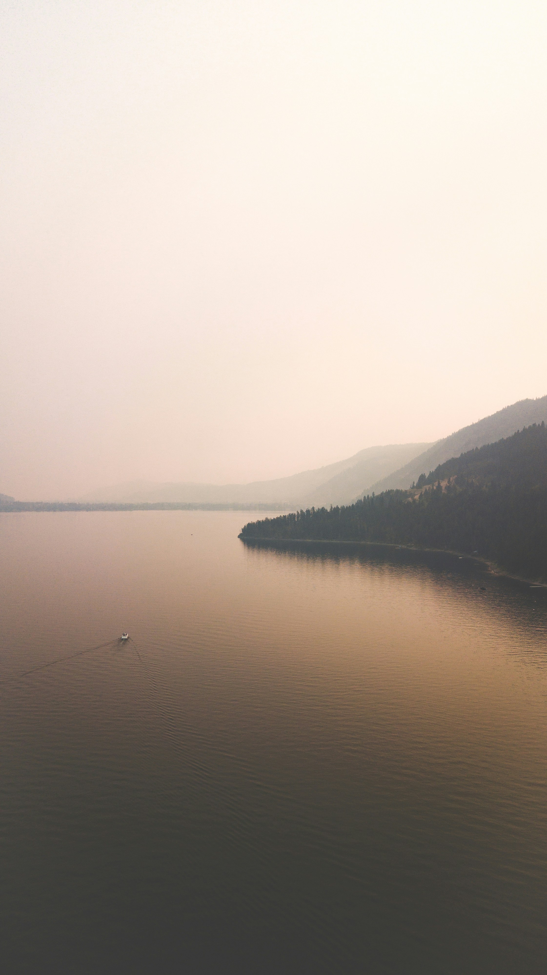 a body of water with hills in the background