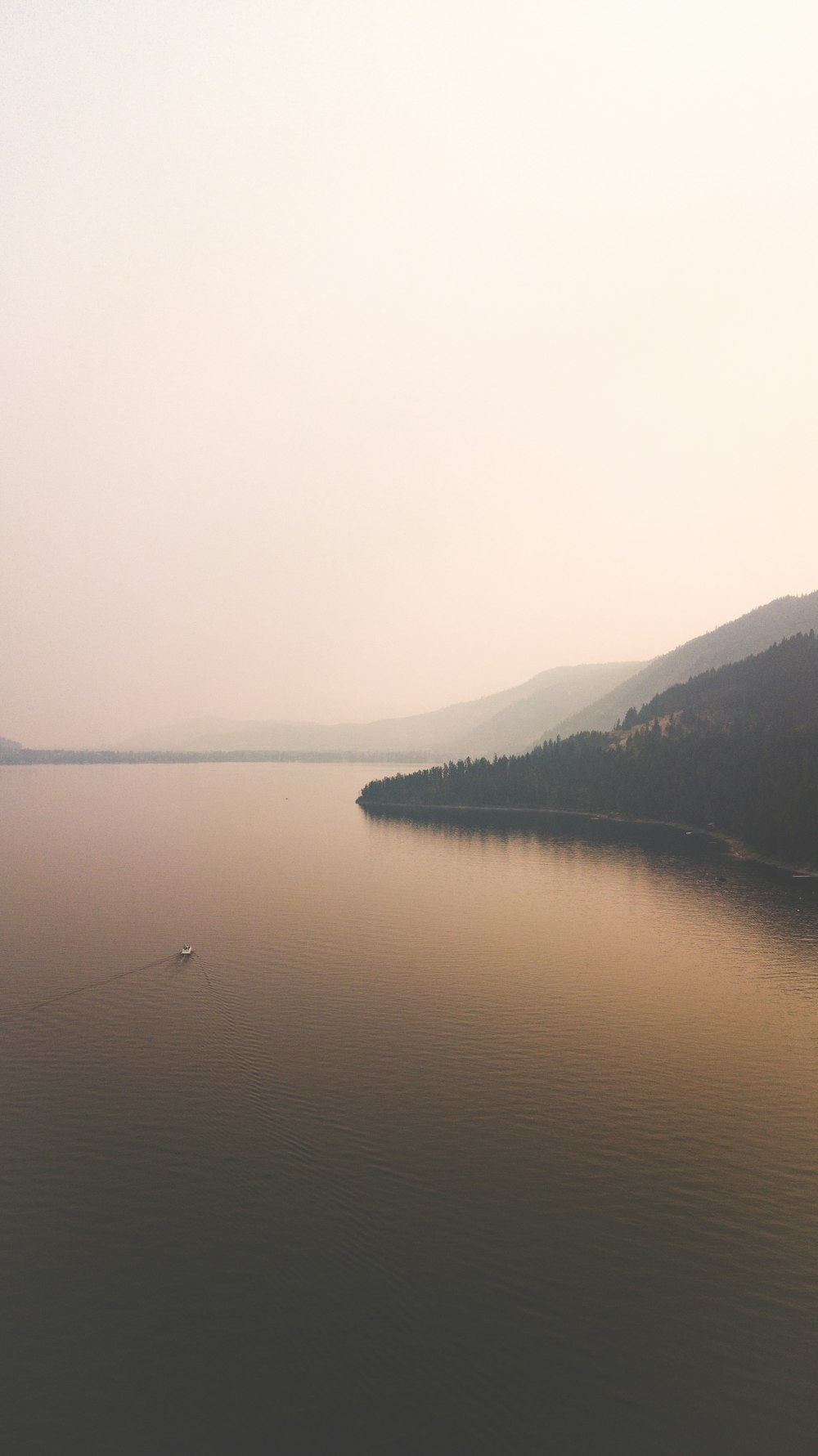 a body of water with hills in the background