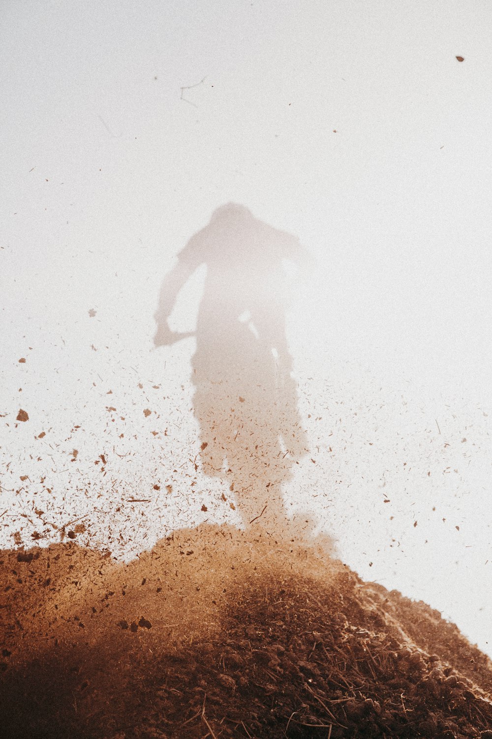 a person's shadow on a beach