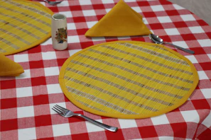 a plate with a yellow circle on it and a fork on it place mats Kanha Universal Export