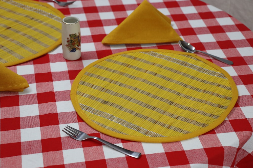 a plate with a yellow circle on it and a fork on it