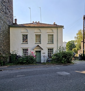 Cozy family house with garden and white picket fence on a quiet street