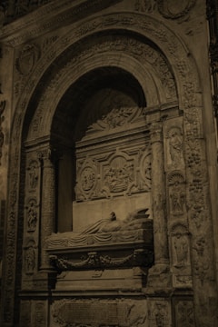 Artistic marble tombstone with intricate engravings and floral motifs.