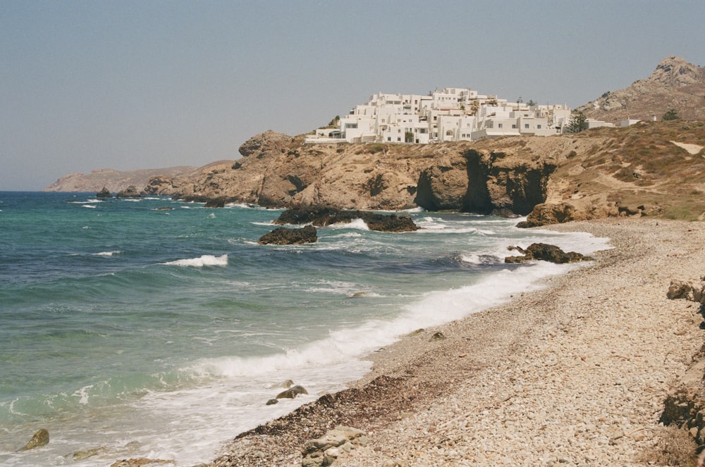 a beach with a building on the shore