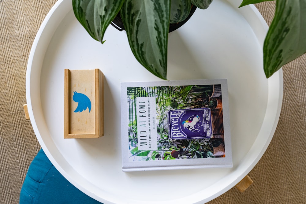 a plate with a picture of a bird and a plant on it