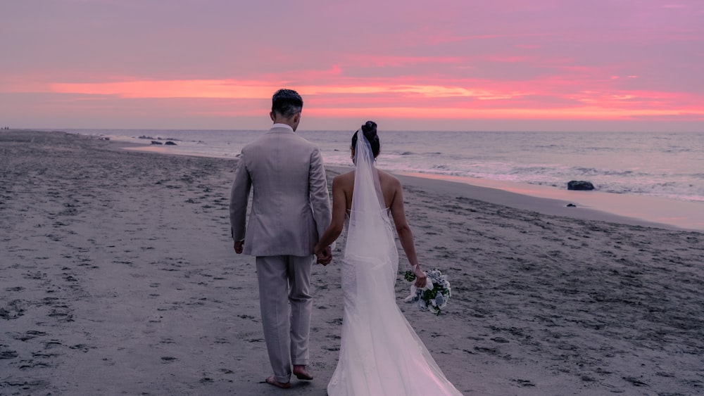 a man and woman walking on a beach