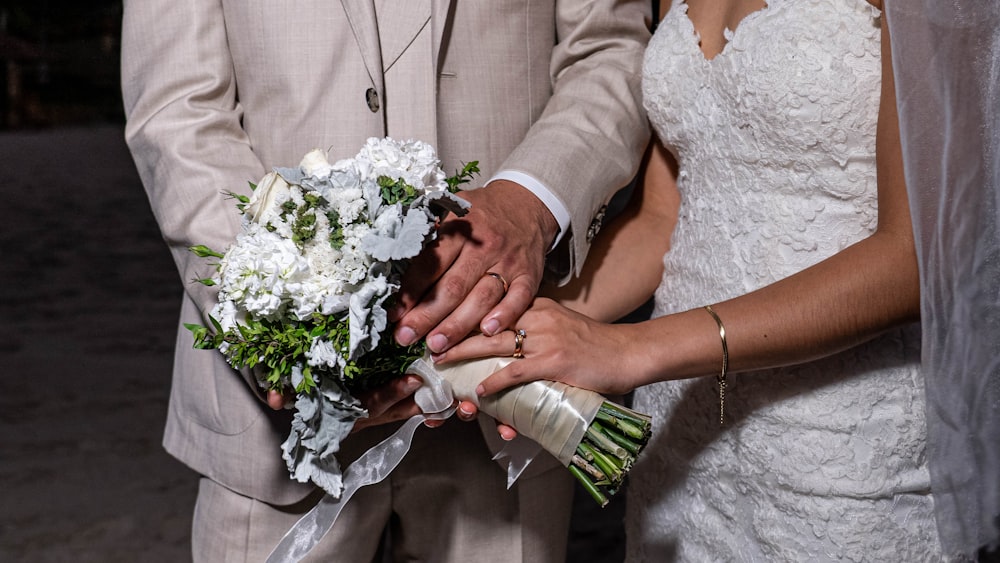 a man and woman holding flowers