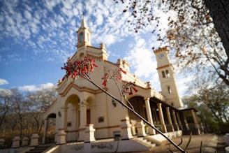 a white building with a tower and a cross on top