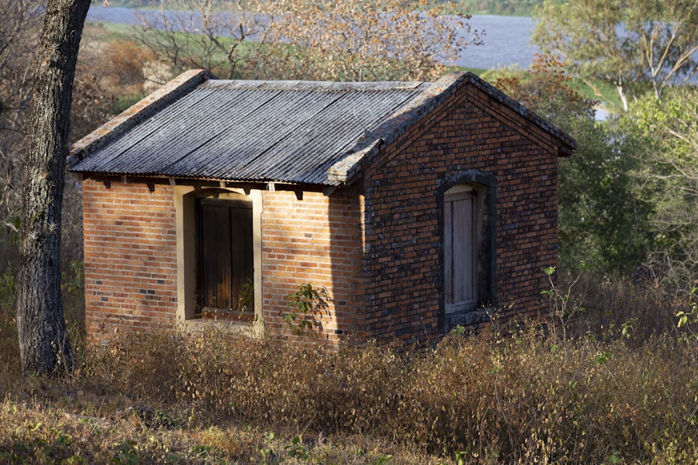 a brick building in a wooded area