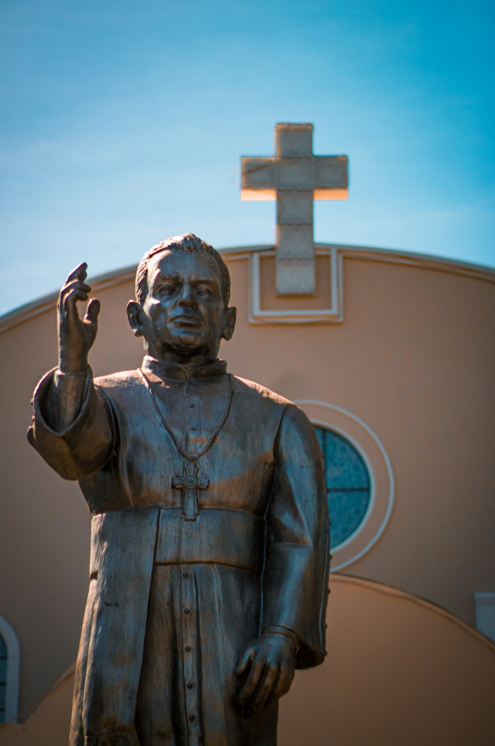 a statue of a person holding a cross