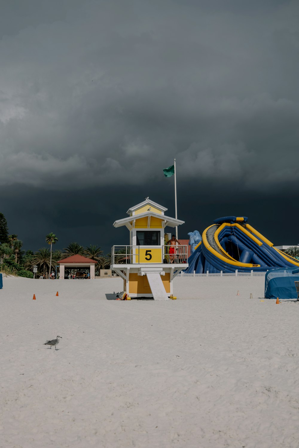 a yellow and white structure on a beach