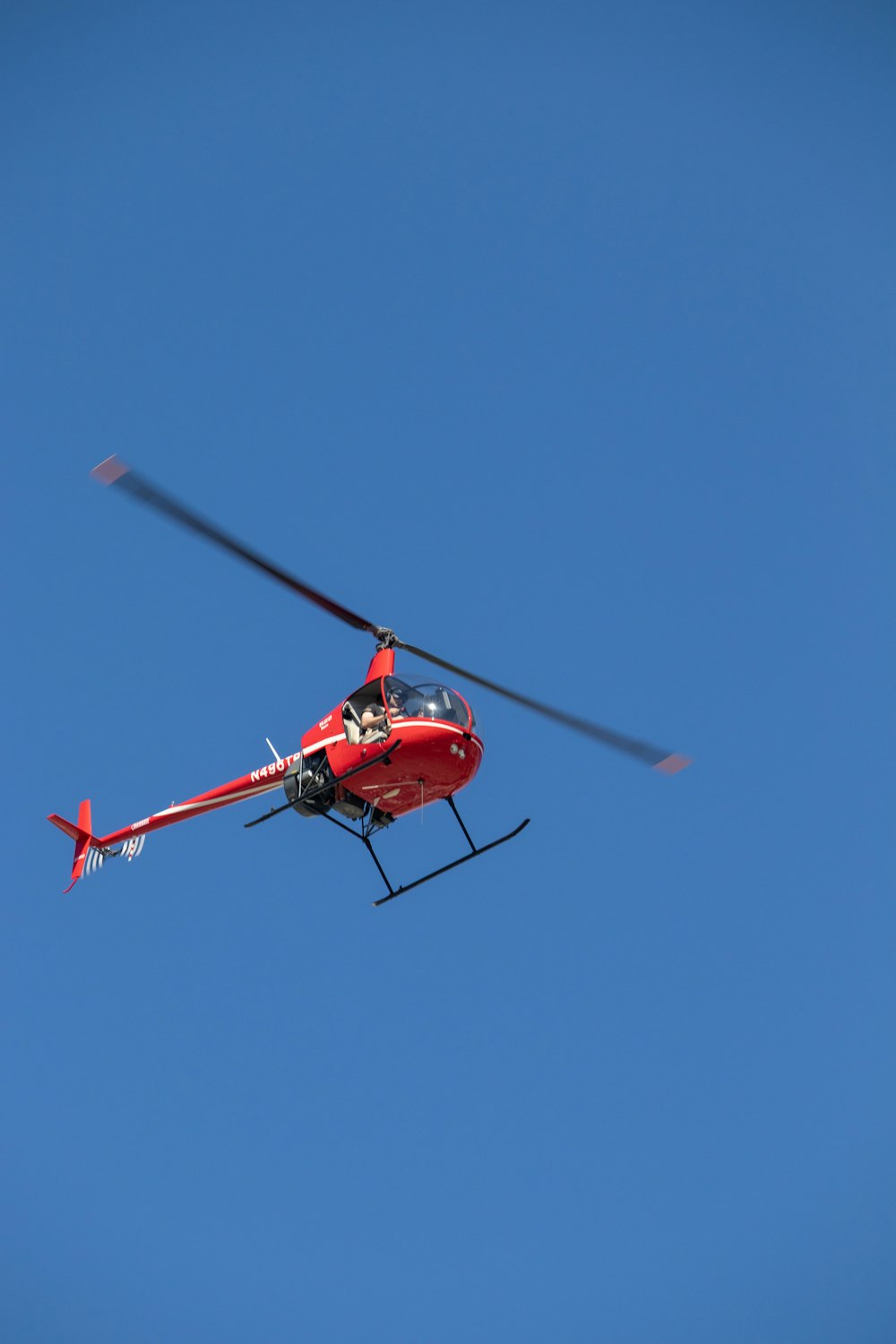 a red helicopter in the sky