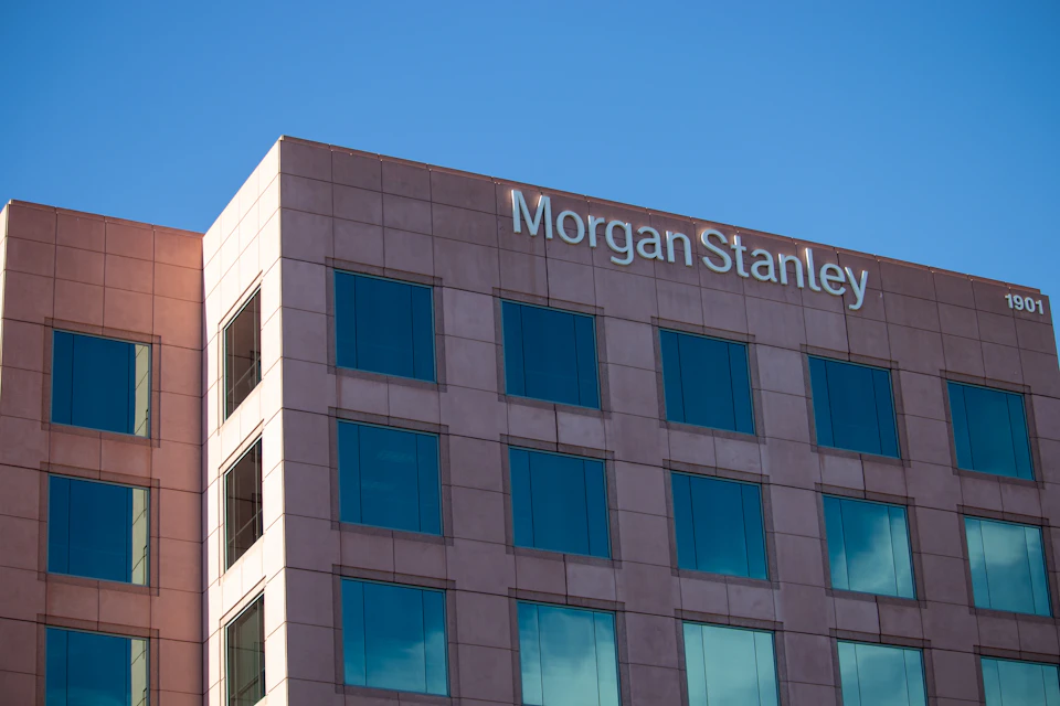 Large, multi-story building with pink and white colors, featuring numerous windows and prominent signage