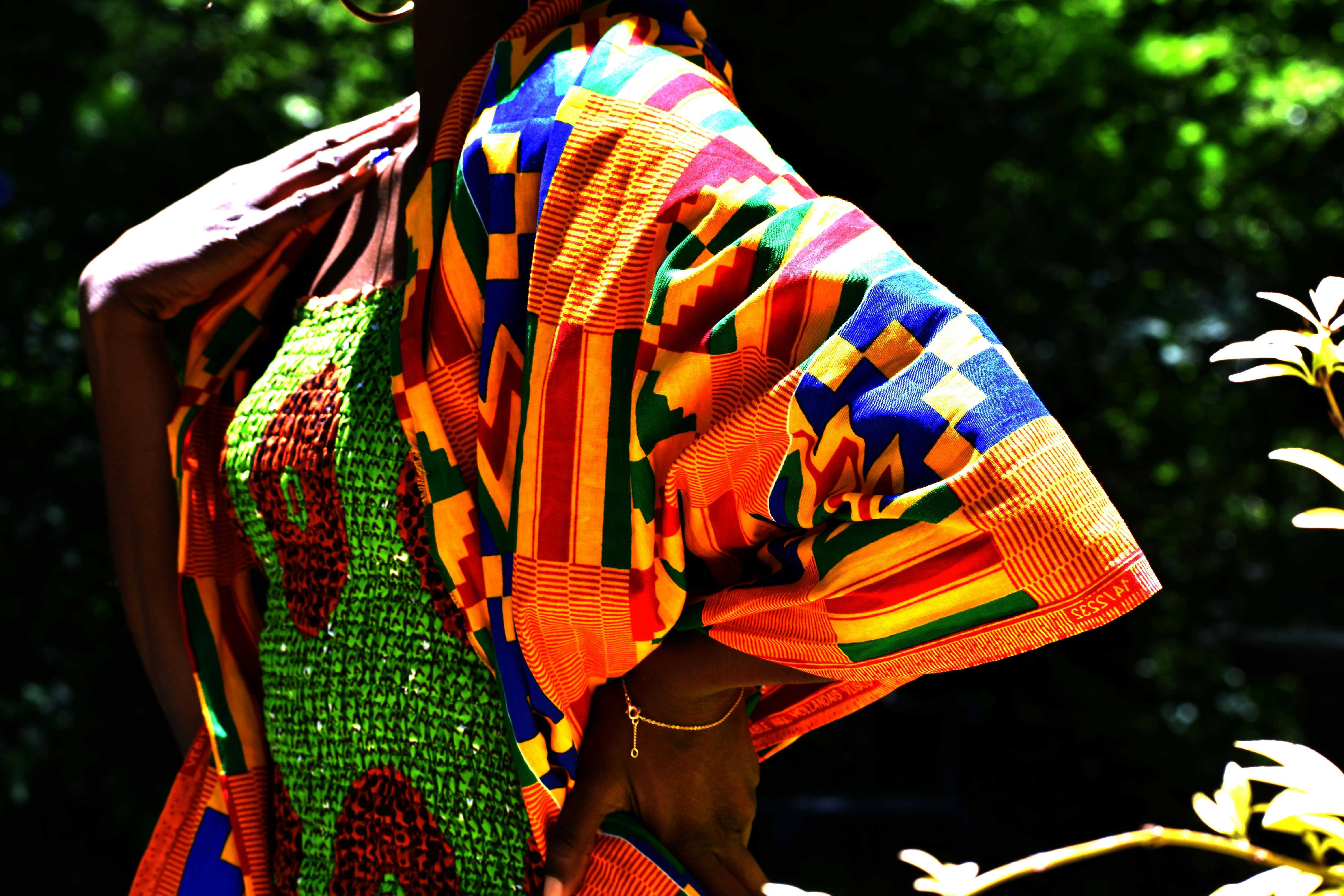 Colorful traditional Kente print fabric dress on bright background