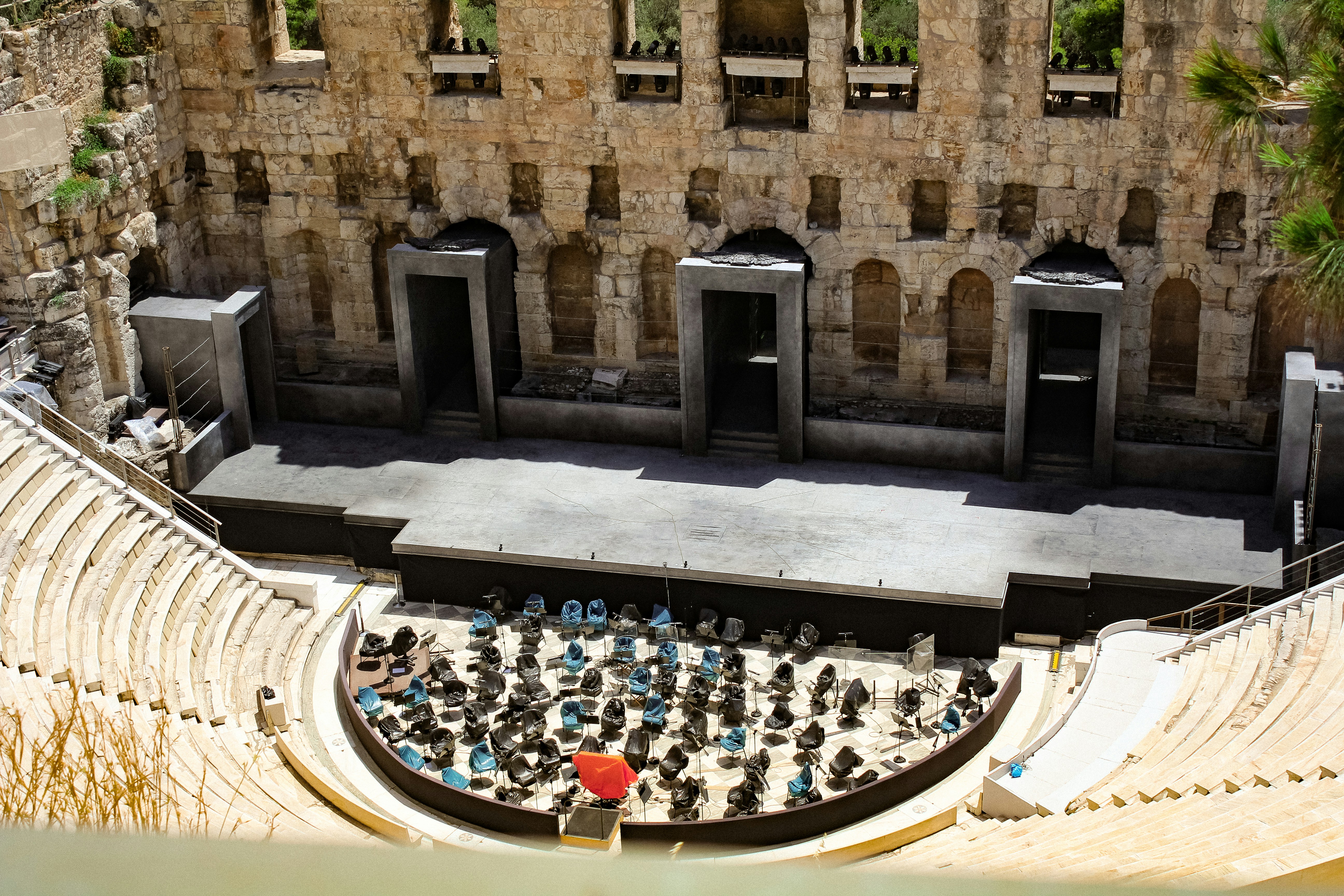 a large group of people in a courtyard with a large stone building