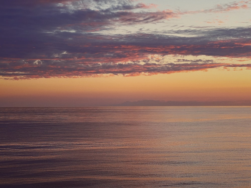 a sunset over a large body of water