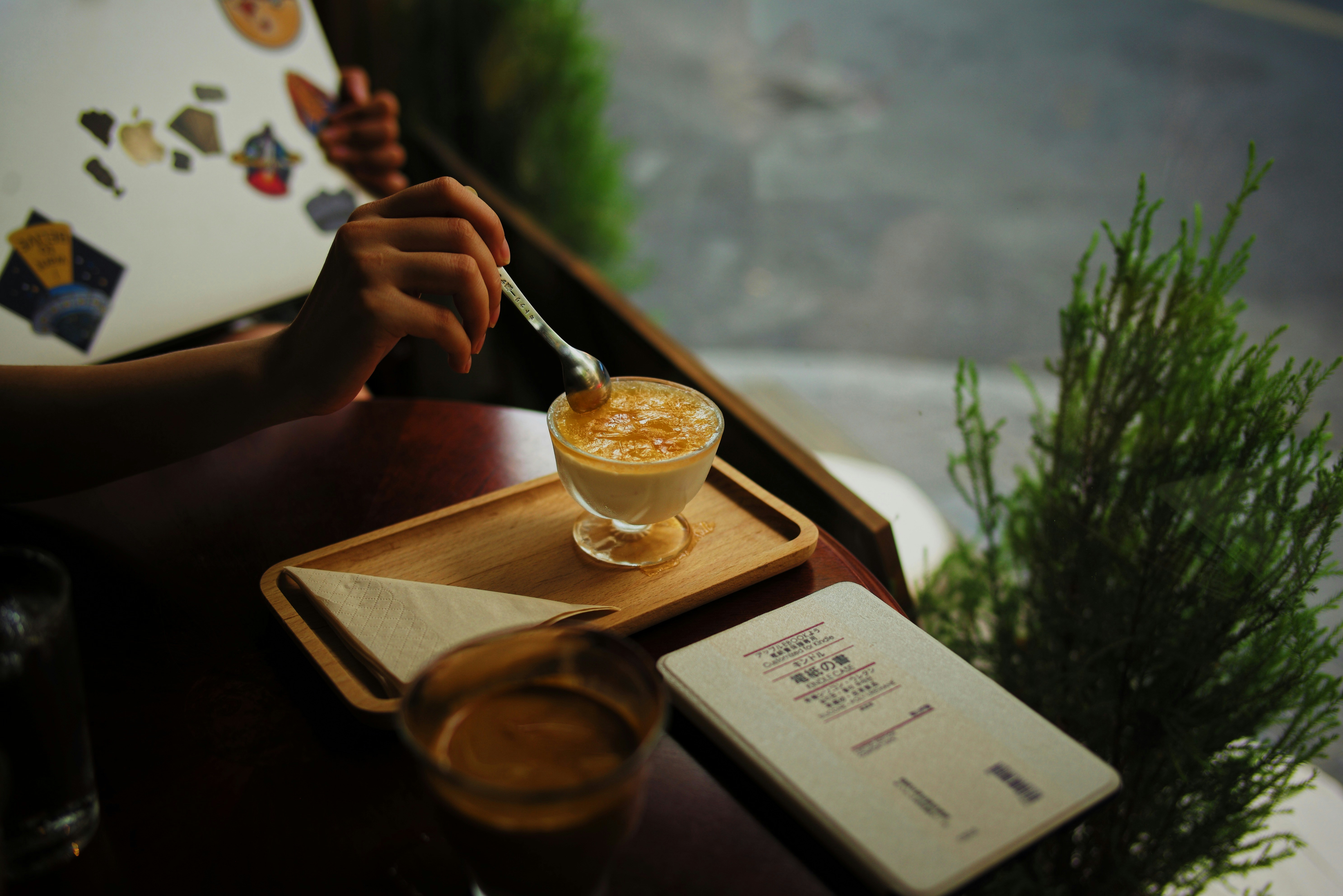 A Person Holding A Fork And A Glass Of Liquid