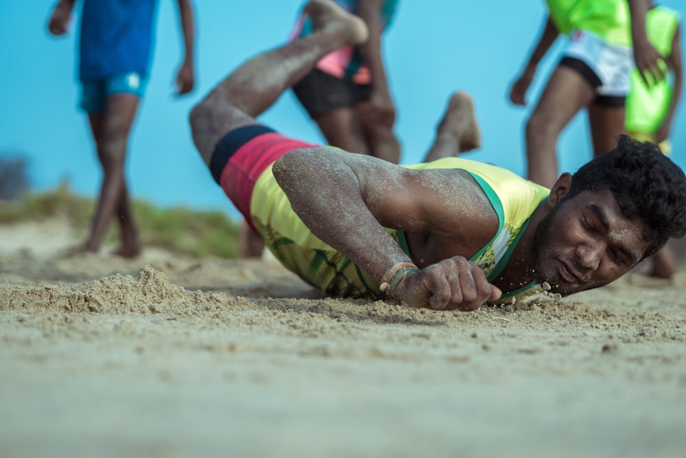 a man lying on the sand