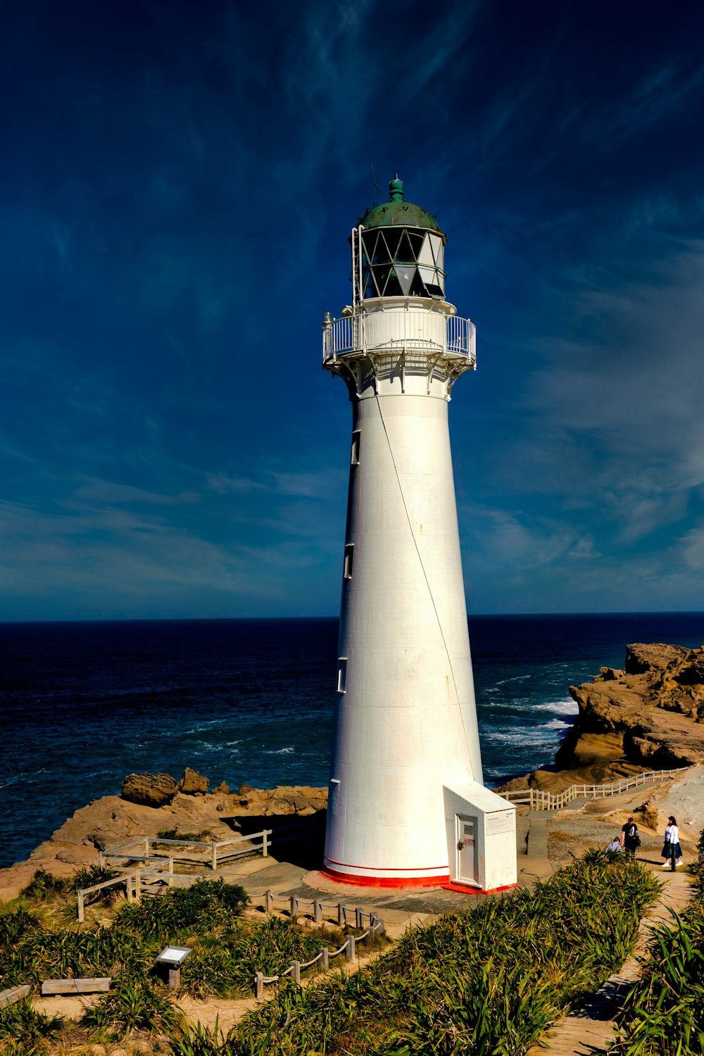 a lighthouse on a rocky beach